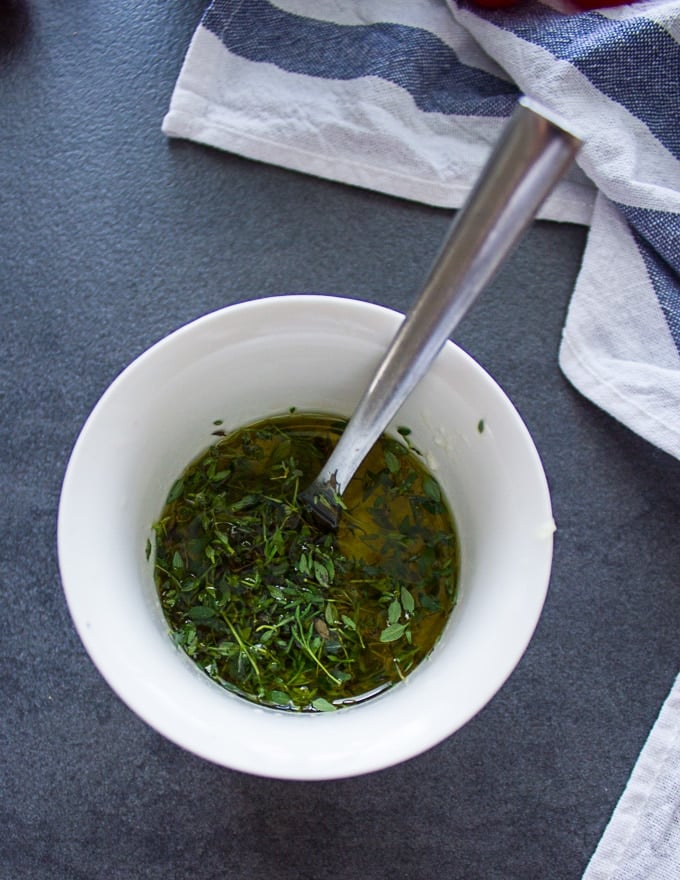a bowl with the dressing ingredients and a spoon in the middle