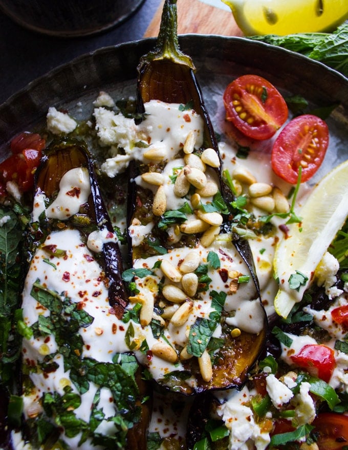 Fried egplant toped with tahini, mint and toasted pine nuts on a bed of tahini sauce