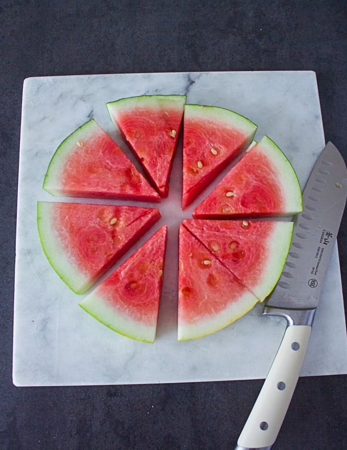 A disc of the watermelon cut up intp eight wedges and ready for the toppings 