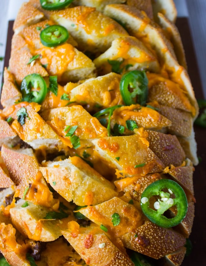 Close up of the middle part of the pull apart bread showing the cheese and filling, and the sliced jalapeno over the top
