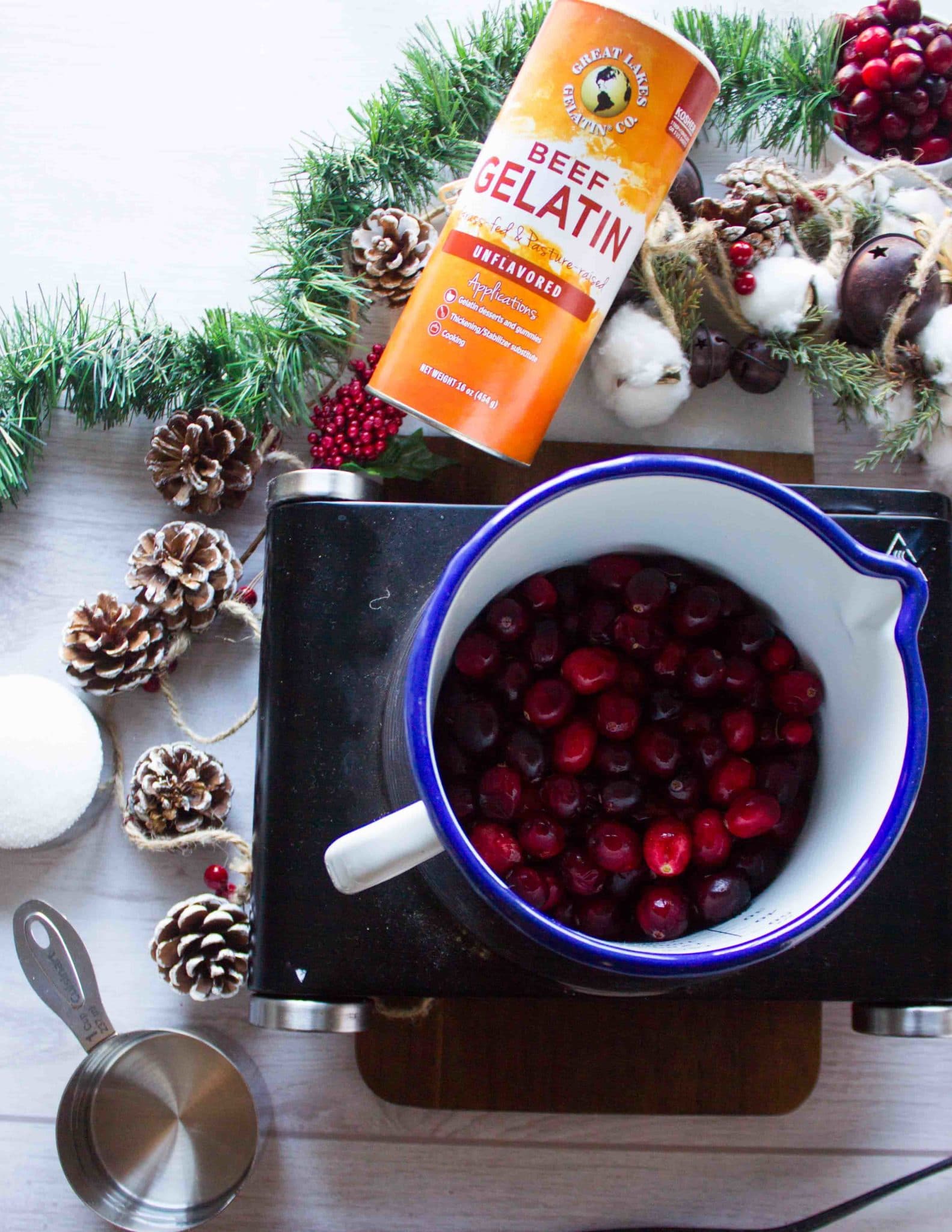 A small cooking pot with the cranberries, water and sugar ready to cook into the sauce 