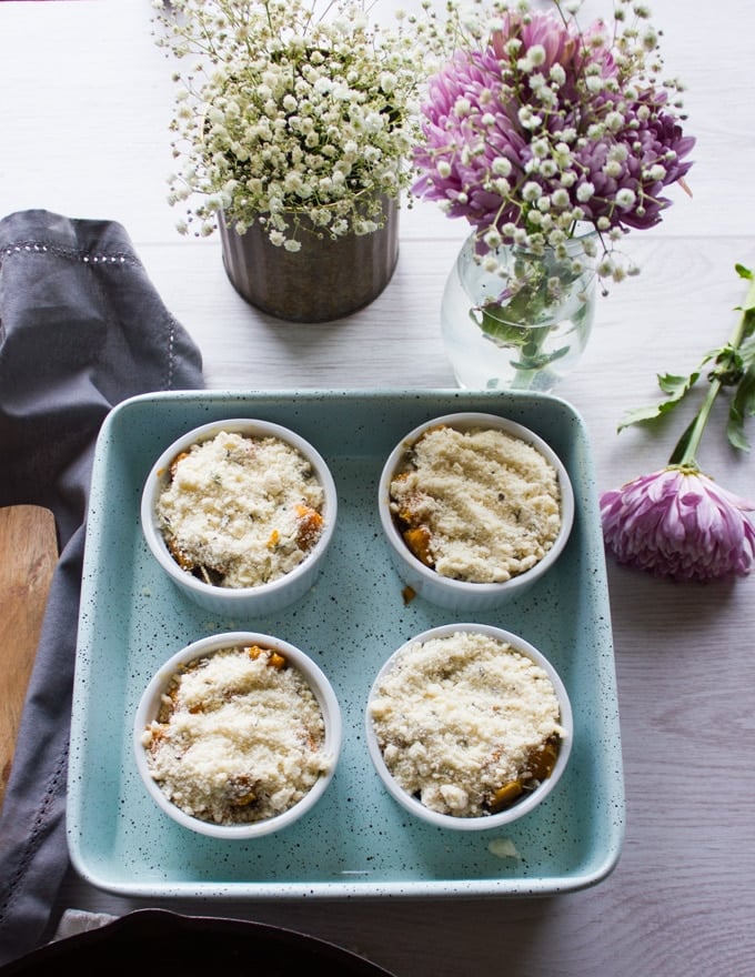 four ramekins with the gratin topping ready to go in the oven