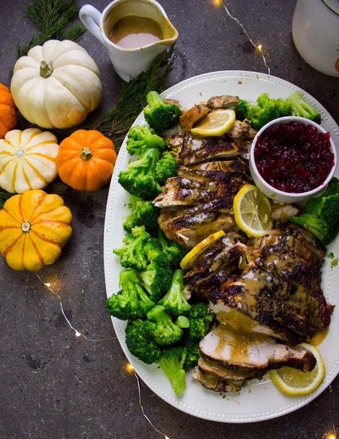 half a plate of turkey breast recipe with pumpkins, gravy and lemon slices