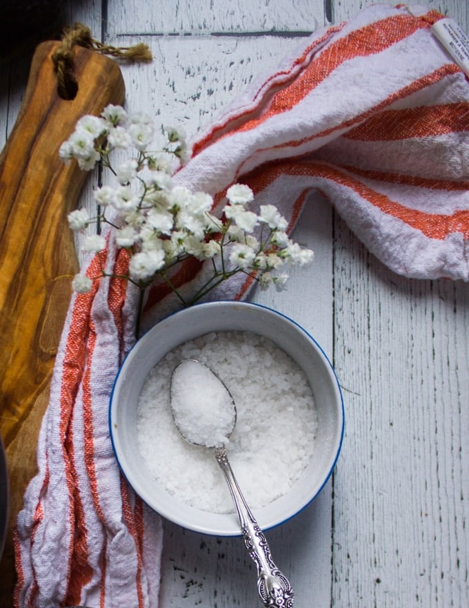 A bowl of salt with a spoon