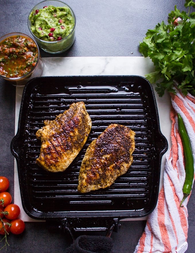 Chicken breasts grilled on a stove grill pan showing the grill marks