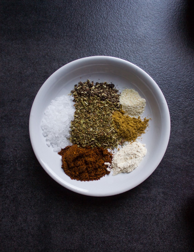 A bowl of the fajita spice including chilli powder, cumin, oregano, salt, pepper, garlic powder, onion powder