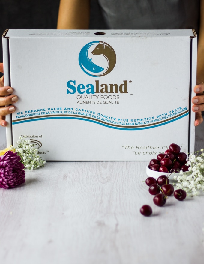 two hands holding a box of Sealand Foods delivery box 