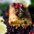 A fillet of baked mahi mahi over black rice and some cherry salsa over the top