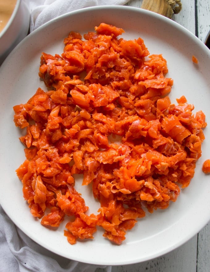 A plate with raw chopped salmon for spucy salmon sushi 