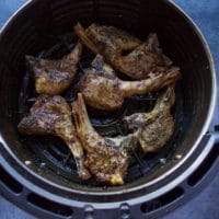 Air fryer lamb chops ready and crispy in the air fryer basket