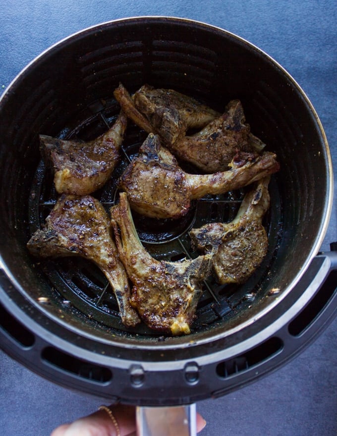 Air fryer lamb chops ready and crispy in the air fryer basket