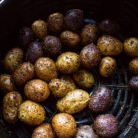 Crispy air fryer potatoes ready and cooked perfectly in the air fryer basket