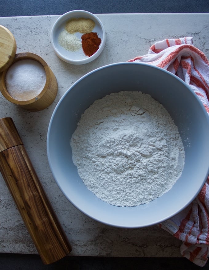 A bowl for fish seasoning including a bowl of flour and a bowl of seasoning spice