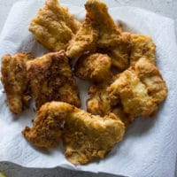 Fish fried and drying on paper towels ready to be served