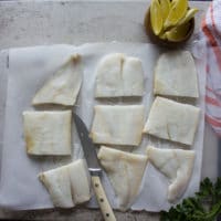 Fish fillets on a white paper and cut up into thirds