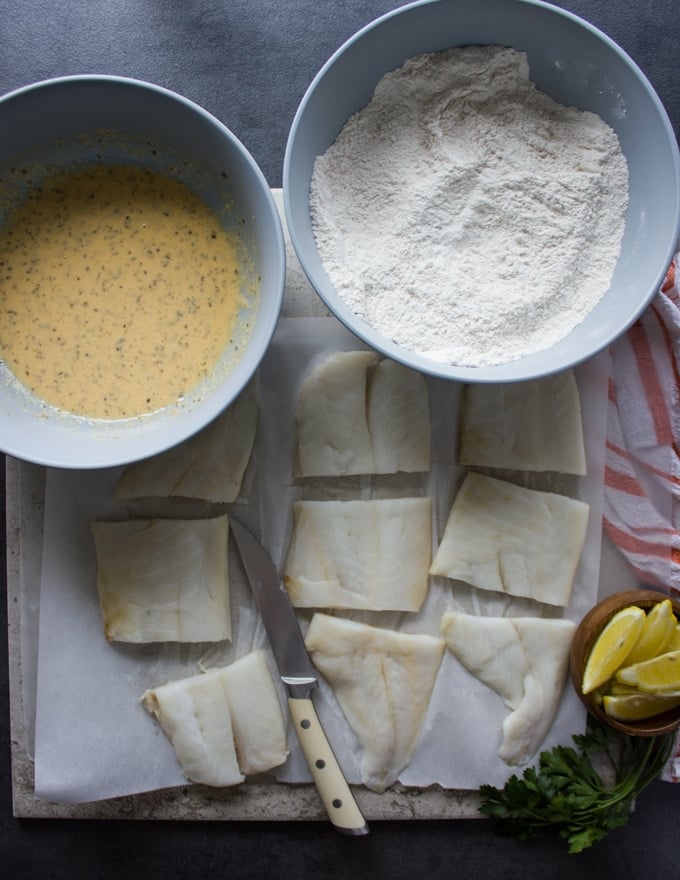 The fish coating bowls are ready and placed over the cut up fish fillets ready for breading before frying