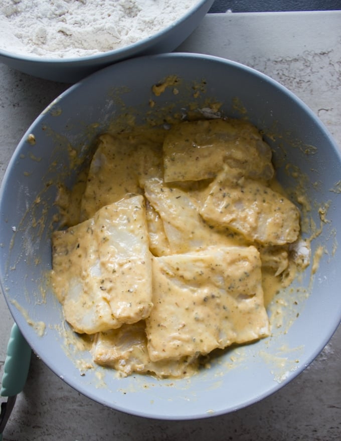 The fish fillets dredged in the egg sticky mixture next for the breading porcess