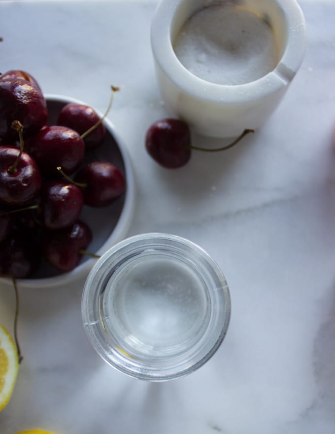 A glass with cold water for the cherry pie filing