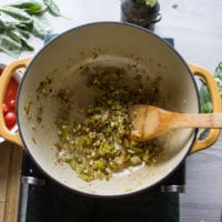 A large pot with sauteed onions, celery and garlic