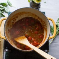 The canned tomatoes added to the huge pot and being cooked for the marinara sauce so we add the mussels