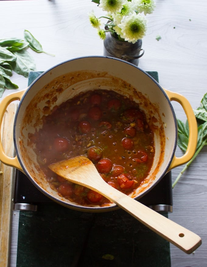 The canned tomatoes added to the huge pot and being cooked for the marinara sauce so we add the mussels