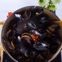 Mussels added into the pot with marinara sauce