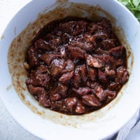 Beef tips added to the sauce and tossed to coat well in a large bowl