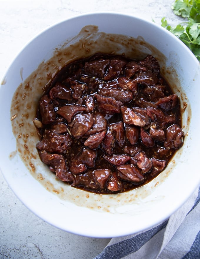 Beef tips added to the sauce and tossed to coat well in a large bowl