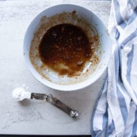 remaining marinade in a bowl with a tablespoon of cornstarch on a marble ready to be added and then coking with the beef tips recipe