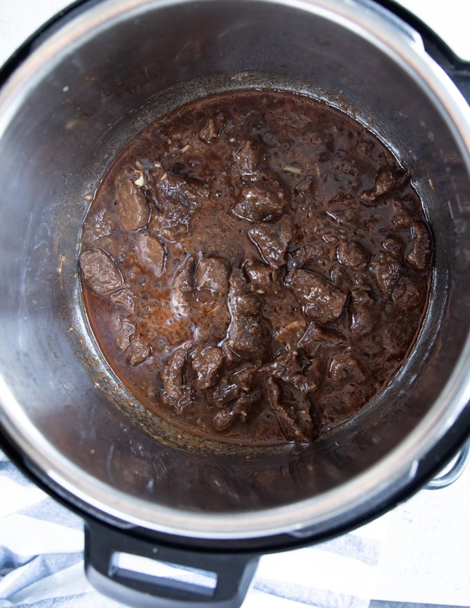 Finished and ready beef tips recipe on the instant pot and stove top ready to serve with rice