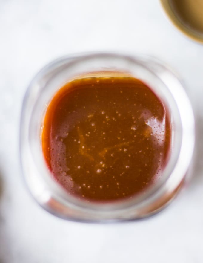 Homemade caramel sauce in a jar.