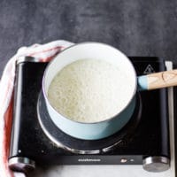 Sugar and water boiling in a pot to make caramel sauce