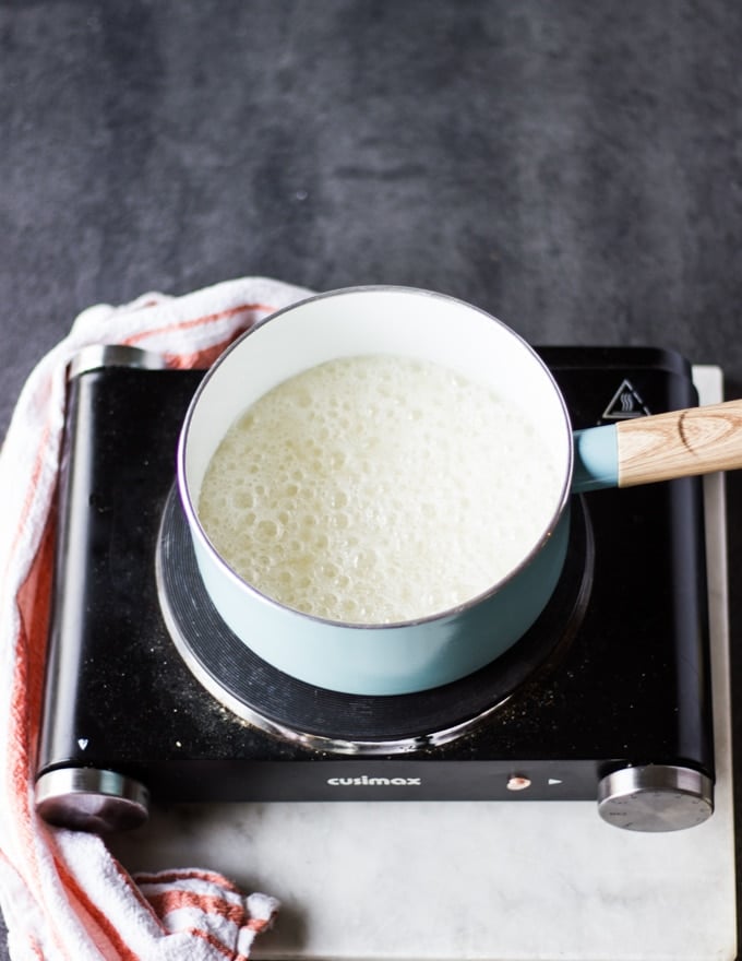 sugar and water becoming syrup in a pan.