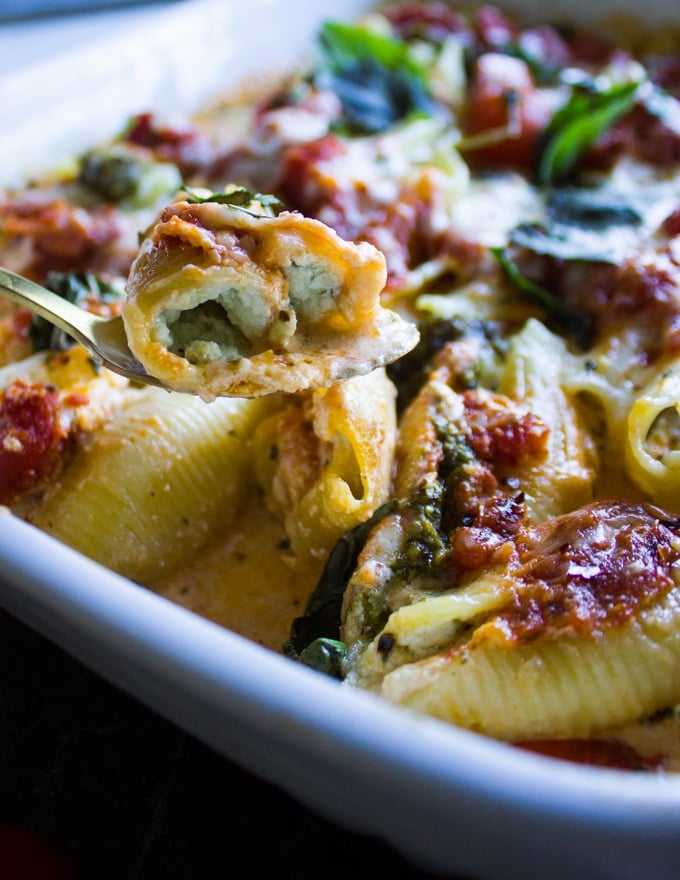 Close-up of a bite of baked ricotta stuffed shells.