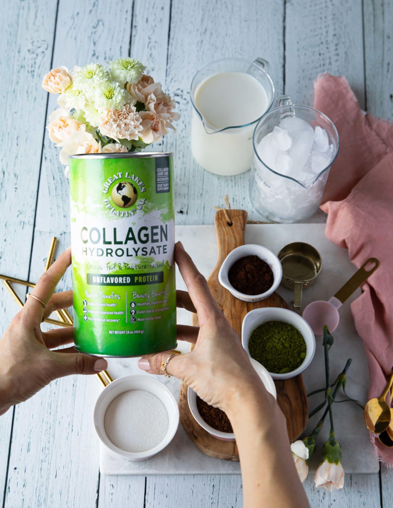 A hand holding a box of collagen to use and fortify the dalgona recipe
