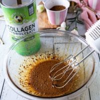 All ingredients to make whipped coffee in a bowl and an electric mixer next to it