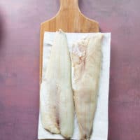 pickerel fillets on a cutting board thawing.