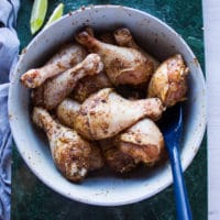 chicken legs coated with the dry spice mix in a bowl