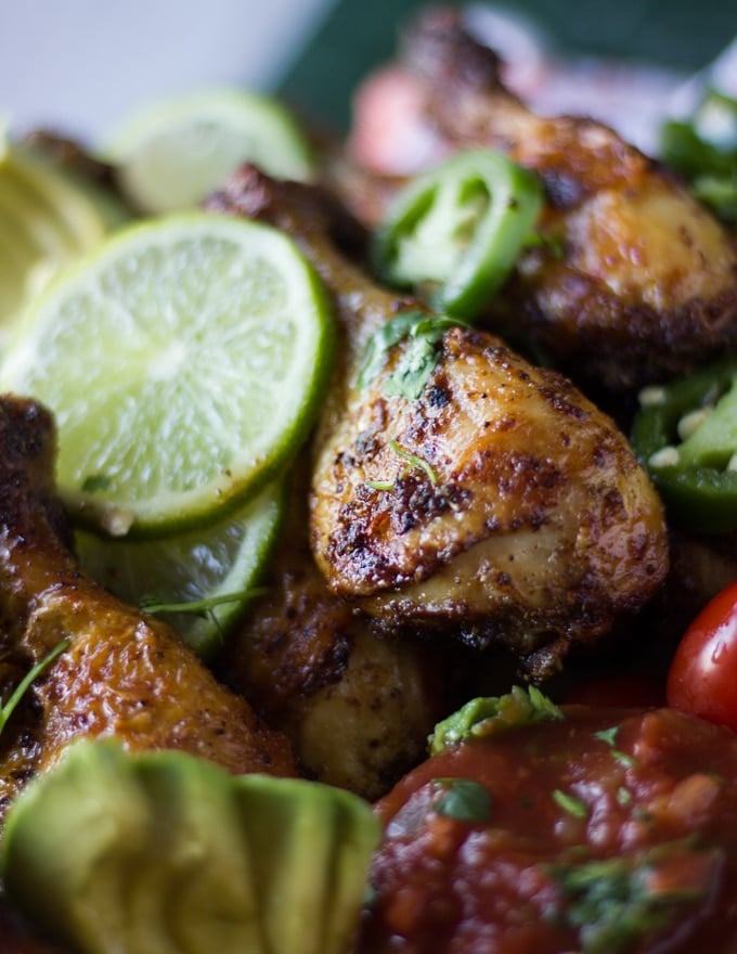 close up of the air fryer chicken leg ready and crispy with lime slices