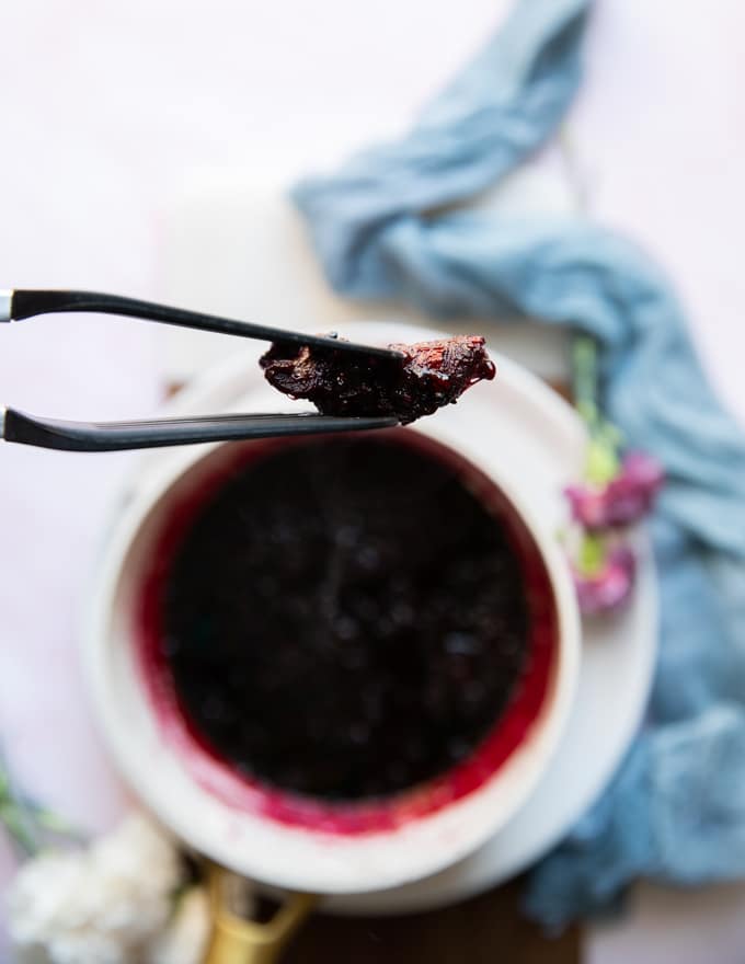 tongs used to remove the cloth of whole wpices once the blackberry jam recipe is finished