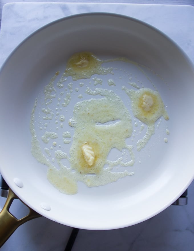 a sauce pan with butter preheating