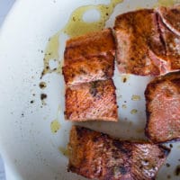 seared sockeye salmon golden and ready, now removing it from the pan to make the sauce