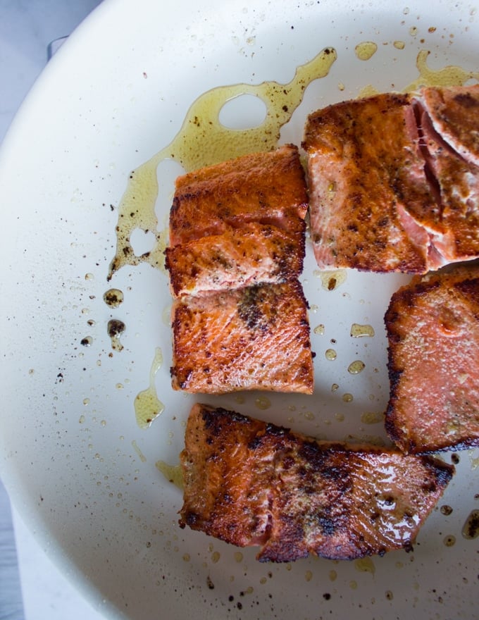 seared sockeye salmon golden and ready, now removing it from the pan to make the sauce