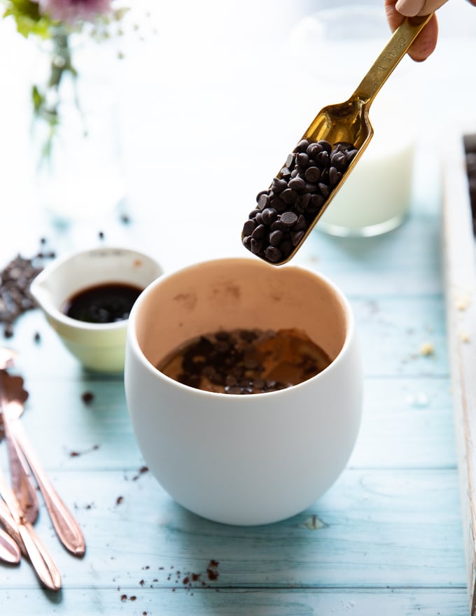 A spoonful of chocolate chips added to the batter to finish off the brownie in a mug ingredients 