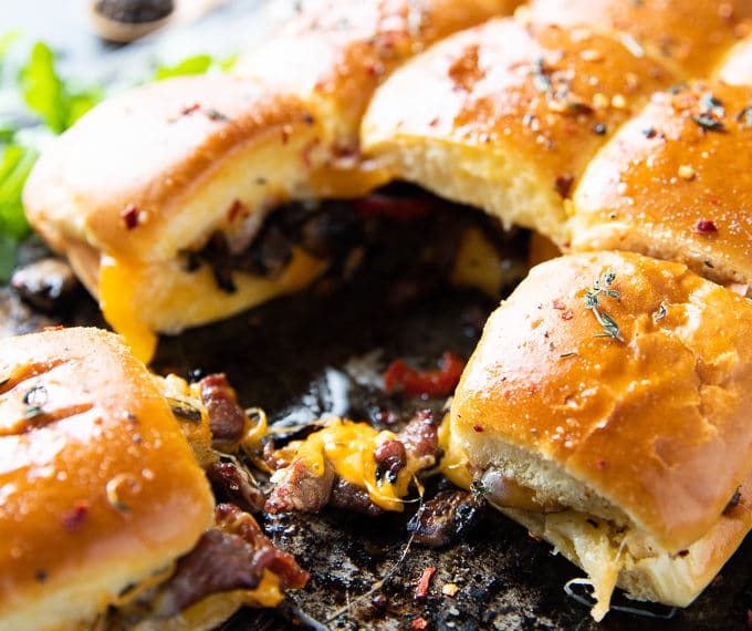 Close up of one Philly Cheesesteak sandwich showing the filling and cheese