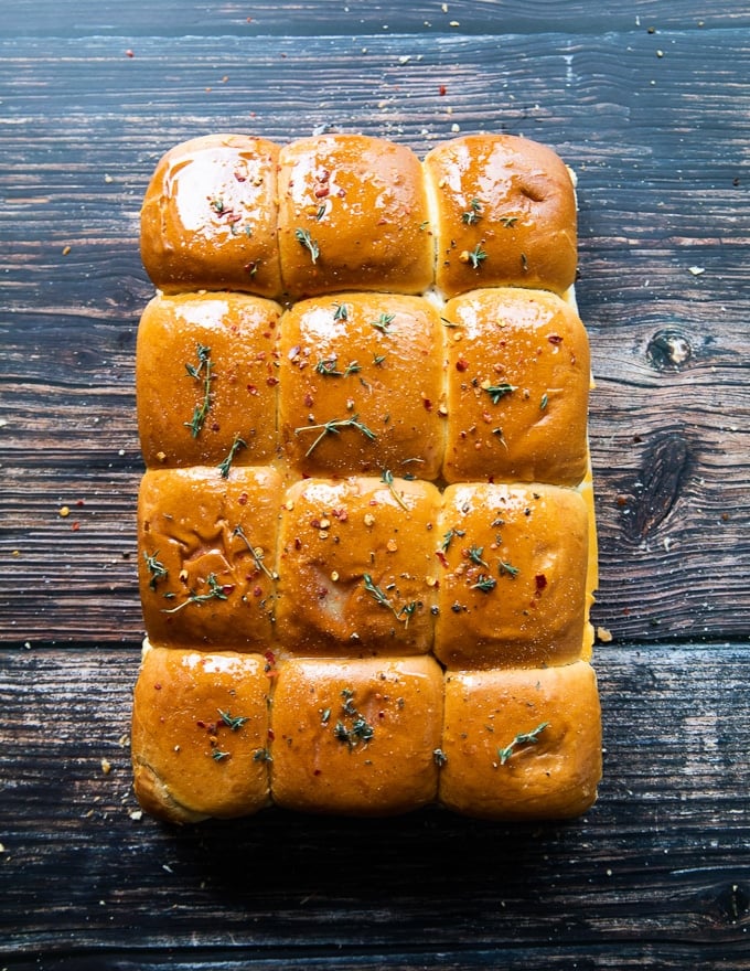 slder bread brushed with melted butter and seasoned, ready to go on the grill or the oven to melt the cheese