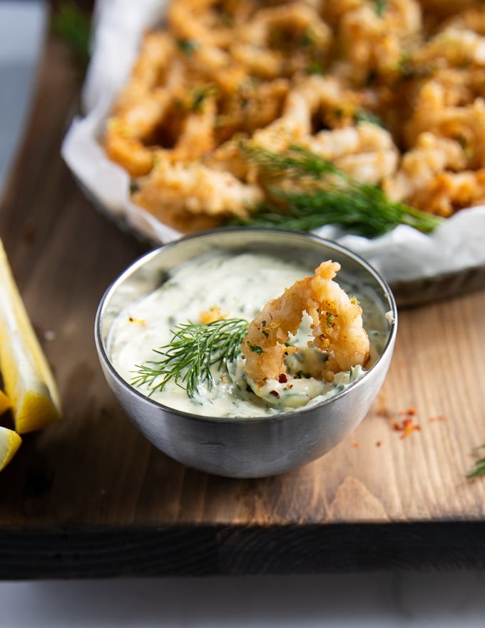 calamari dipped in tartar sauce, close-up view.