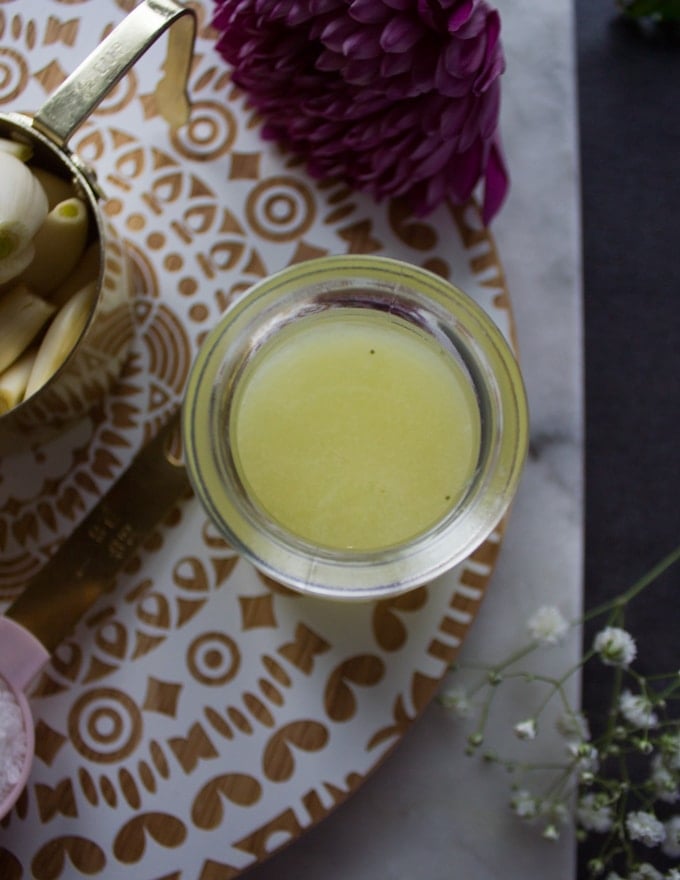 lemon juice in a small cup used to make toum 