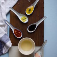 ingredients for the papaya salad dressing including rice vinegar, honey, chilli sauce, soy sauce,