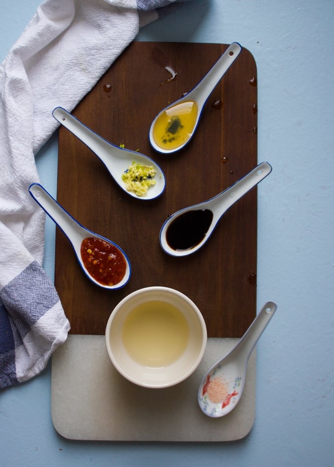 ingredients for the papaya salad dressing including rice vinegar, honey, chilli sauce, soy sauce, 